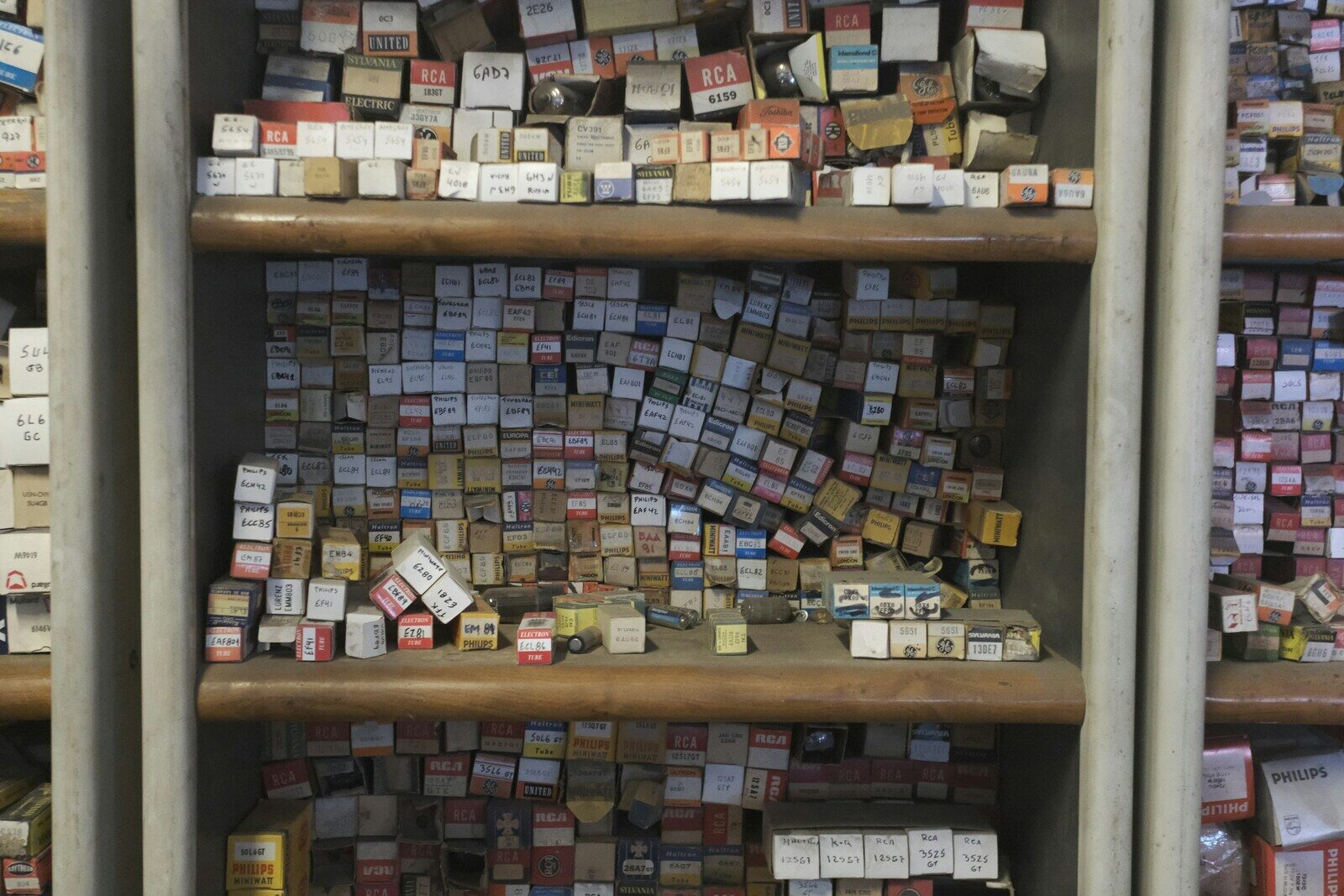 Wooden shelves crammed with hundreds of labelled component boxes.